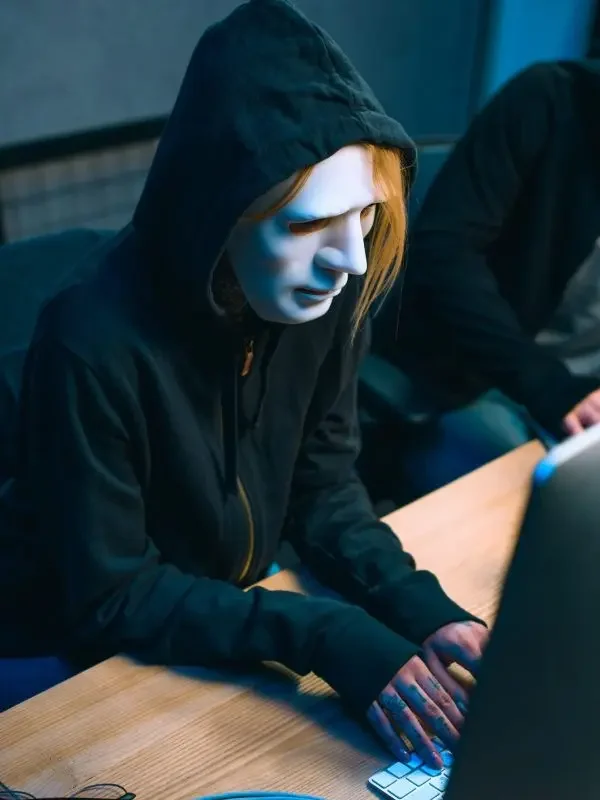 high-angle-view-of-hacker-in-mask-working-with-computer-to-develop-malware-e1687534353677-q8e4ut42wfxhnor3ys6g25a4lwnby43l8cqwl3volc
